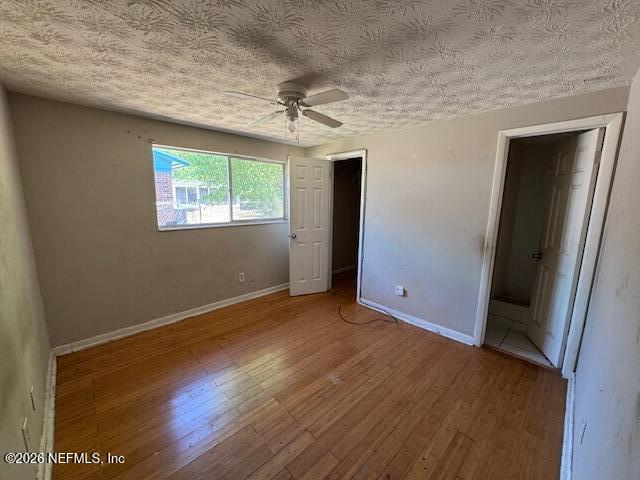 4368 Bedivere Road Jacksonville, FL 32208 - Photo 11 of 20 an empty room with wooden floor and windows