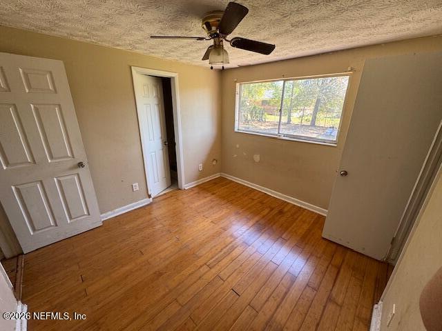 4368 Bedivere Road Jacksonville, FL 32208 - Photo 12 of 20 a view of empty room with wooden floor and fan