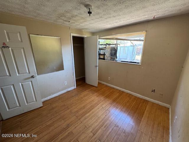 4368 Bedivere Road Jacksonville, FL 32208 - Photo 16 of 20 a view of an empty room with wooden floor and a window