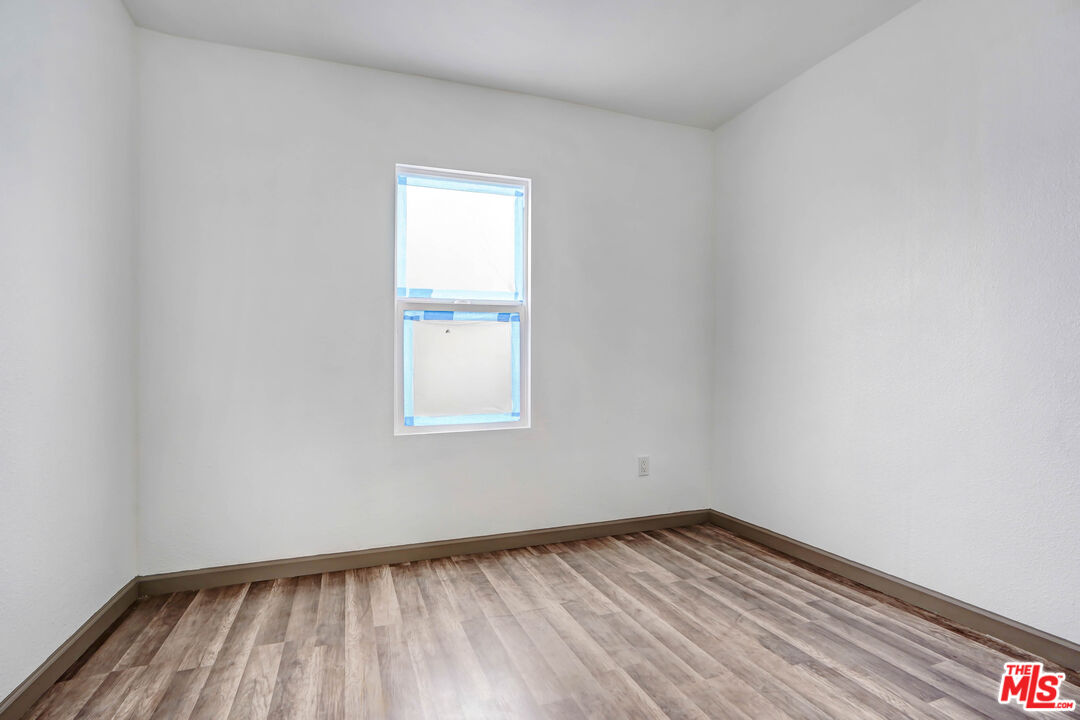 7594 Peters Street Riverside, CA 92504 - Photo 11 of 16 a view of empty room with wooden floor and fan