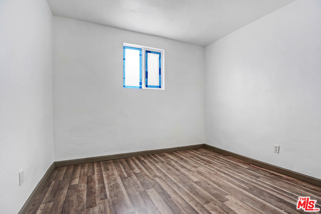 7594 Peters Street Riverside, CA 92504 - Photo 13 of 16 a view of empty room with wooden floor
