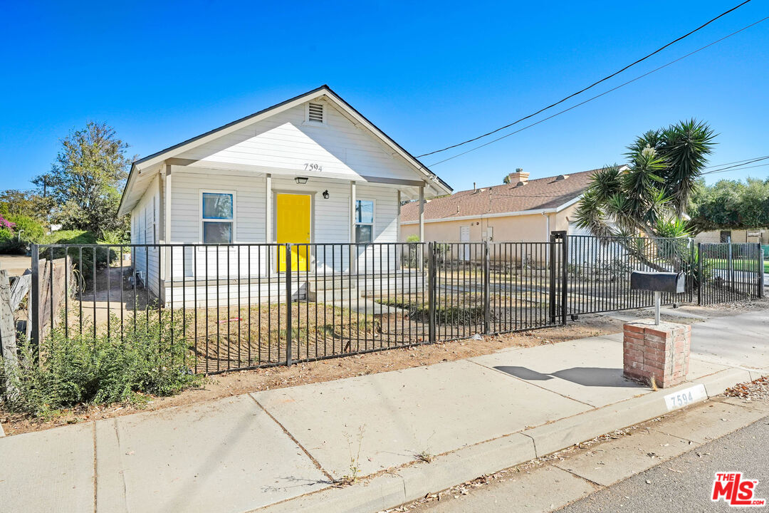 7594 Peters Street Riverside, CA 92504 - Photo 4 of 16 a view of a house with a small yard and plants