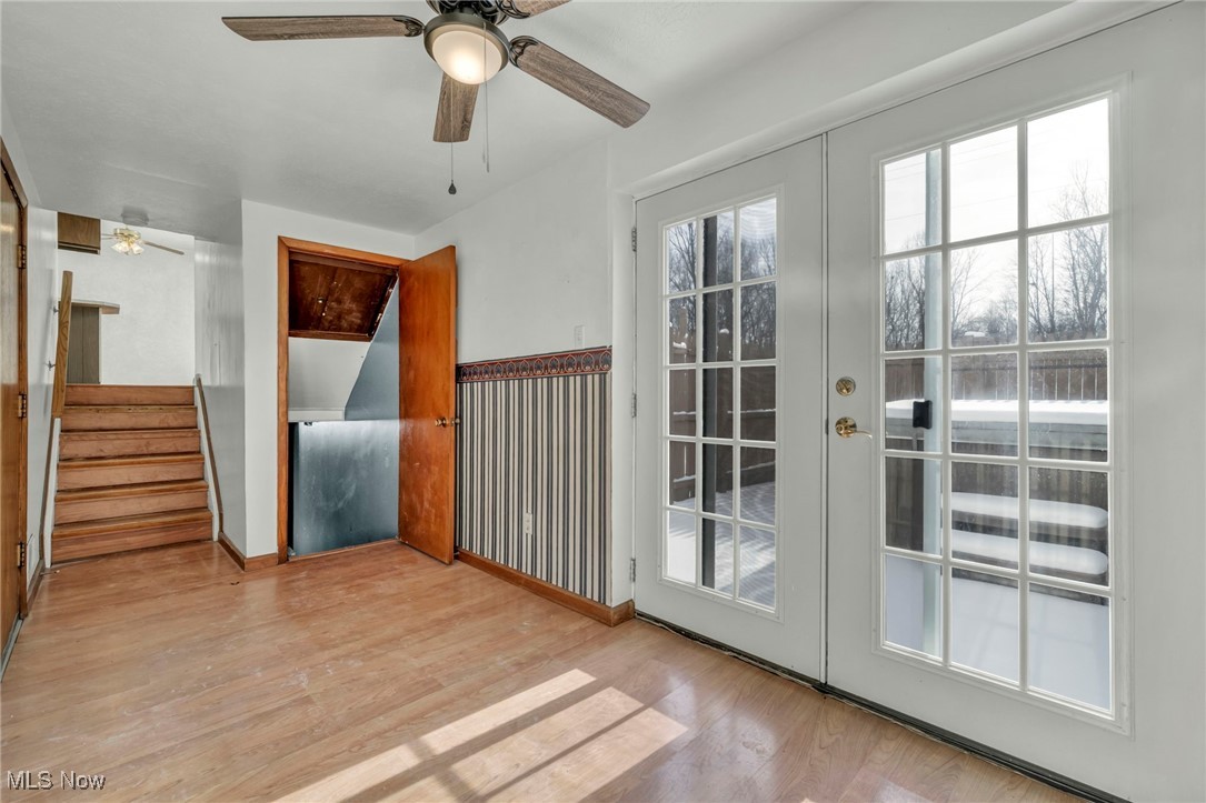 2514 Primewood Road Akron, OH 44305 - Photo 26 of 49 Doorway with stairs, french doors, wood finished floors, and a ceiling fan