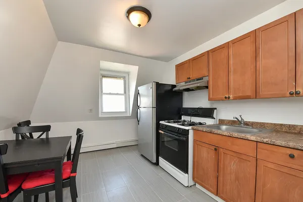 a kitchen with a stove a sink and a microwave