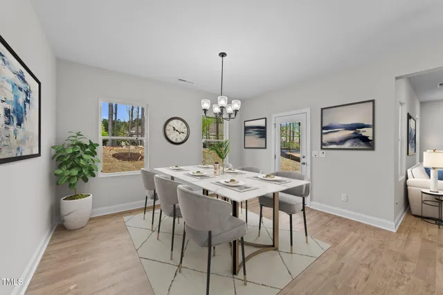 a view of a dining room with furniture and chandelier