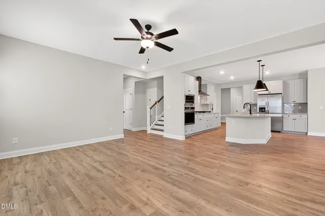 a view of a kitchen with a sink and wooden floor