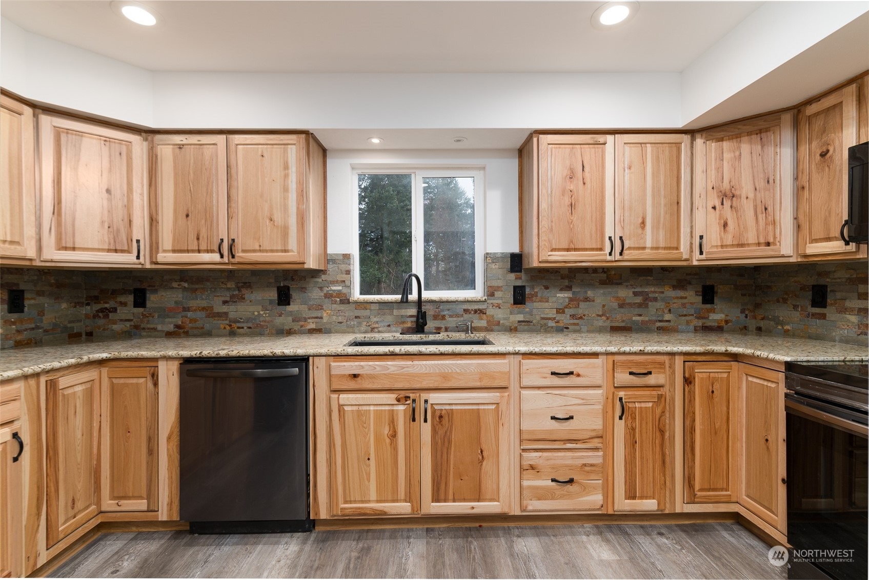 8120 Delta Line Road Custer, WA 98240 - Photo 11 of 40 a kitchen with granite countertop wooden cabinets a sink and a window