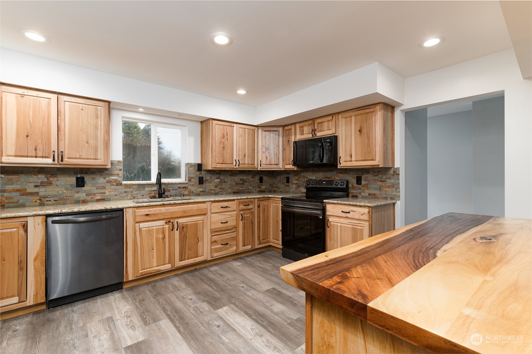 8120 Delta Line Road Custer, WA 98240 - Photo 10 of 40 a kitchen with granite countertop a stove top oven sink and cabinets