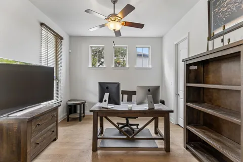 a work room with furniture and a flat screen tv