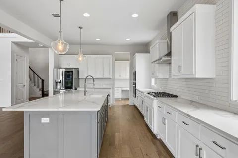 a kitchen with kitchen island a sink stainless steel appliances and cabinets