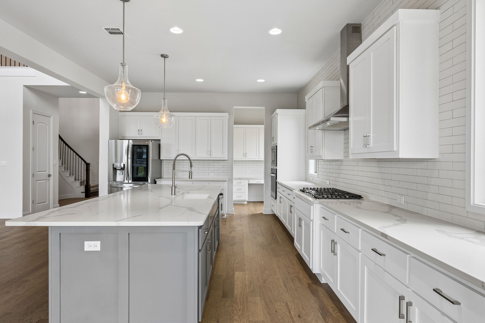7212 Celebration Court Leander, TX 78645 - Photo 16 of 39 a kitchen with kitchen island a sink stainless steel appliances and cabinets