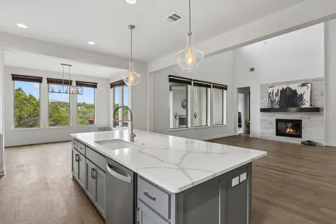 a kitchen with a stove center island and a wooden floor