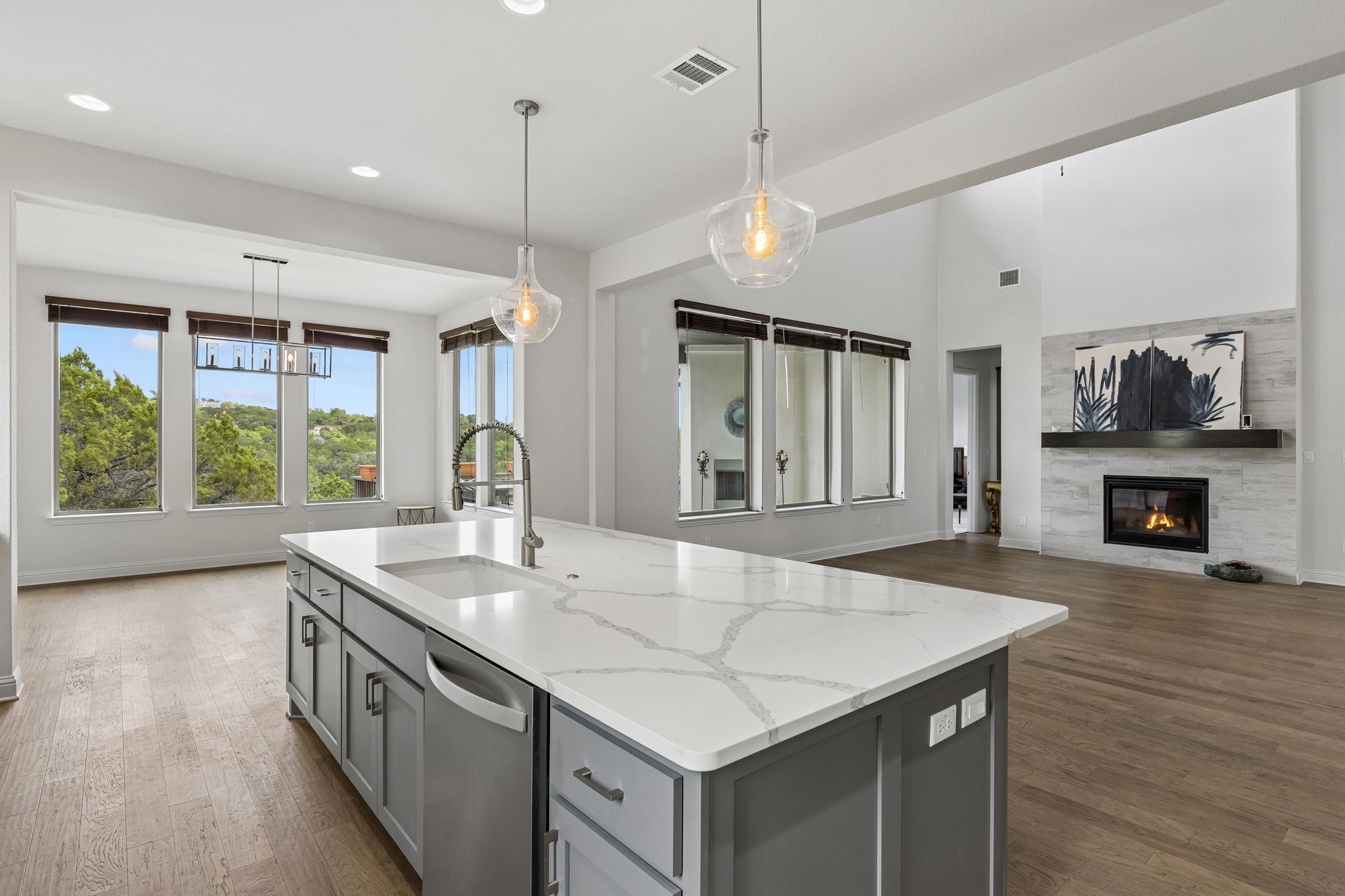 7212 Celebration Court Leander, TX 78645 - Photo 18 of 39 a kitchen with a stove center island and a wooden floor