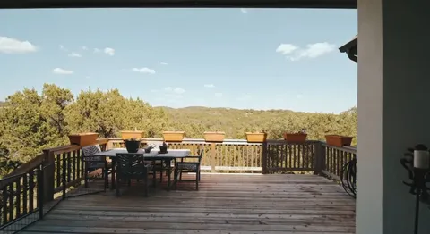 an aerial view of a house with a yard and lake view