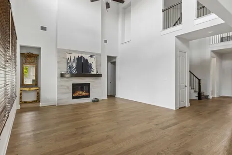 a view of a livingroom with wooden floor and a fireplace