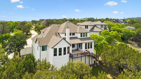a aerial view of a house with yard porch and furniture
