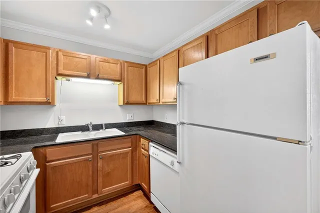 a kitchen with a refrigerator a sink and cabinets