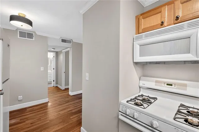a view of kitchen appliances with wooden floor