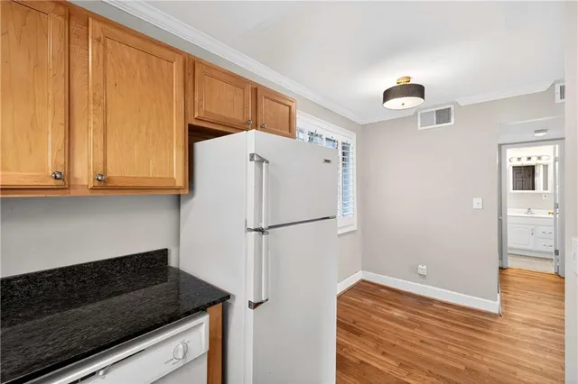a white refrigerator freezer sitting inside of a kitchen