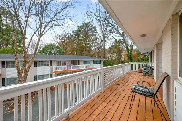 a view of balcony with wooden floor and fence