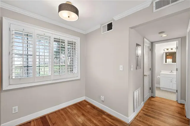 a view of a room with wooden floor and windows