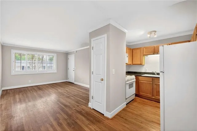 a kitchen with granite countertop wooden floors and stainless steel appliances