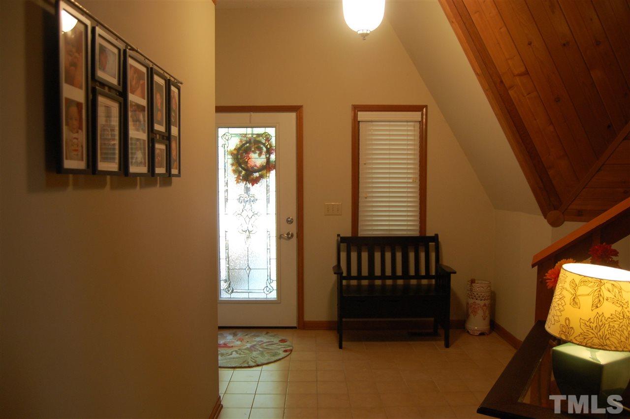 1121 Batchelor Road Apex, NC 27523 - Photo 3 of 30 Entry foyer w/tile, new light fixture in foyer, Shiplap wood that matches the home is on the walls and ceiling – stunning! Roof – 5 years old!