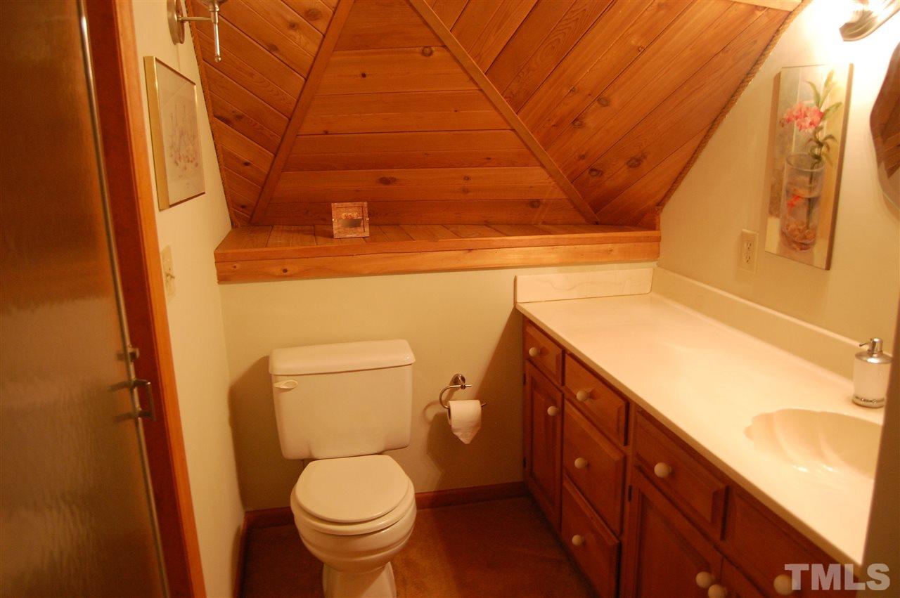 1121 Batchelor Road Apex, NC 27523 - Photo 22 of 30 Master Bath 2/Guest Bath is private w/carpet, cultured marble vanity & shelving below, shell shaped sink w/lots of counter top space & back wall & shelf are shiplap!