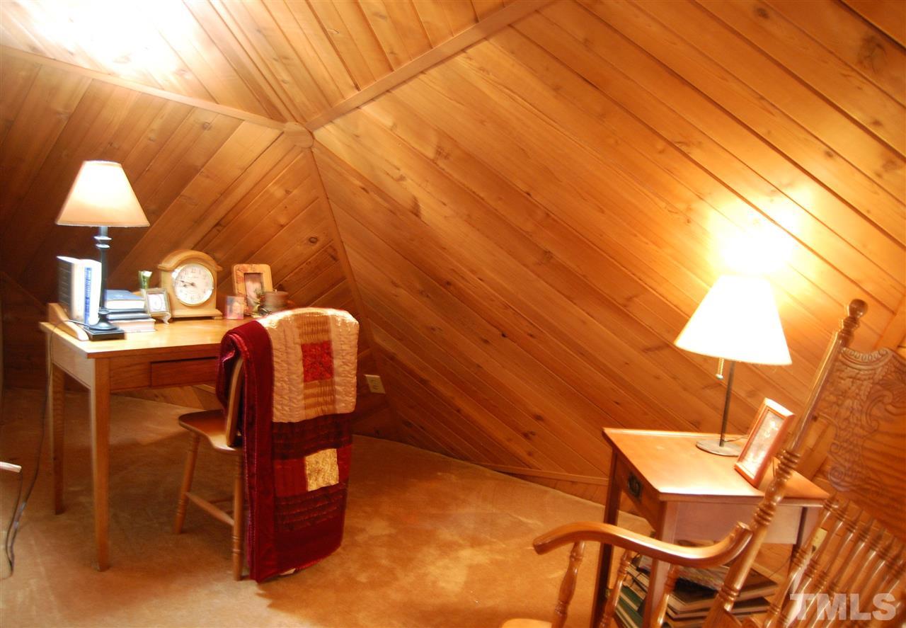 1121 Batchelor Road Apex, NC 27523 - Photo 23 of 30 Upstairs Loft (10x8) w/carpet, electrical outlets, wall light & shiplap walls is being used as an office/play room!