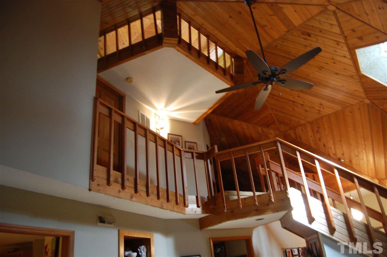 1121 Batchelor Road Apex, NC 27523 - Photo 24 of 30 View from first floor to second floor to third floor cupola, Cupola w/carpet, shiplap & 5 roll out windows; one from each side!