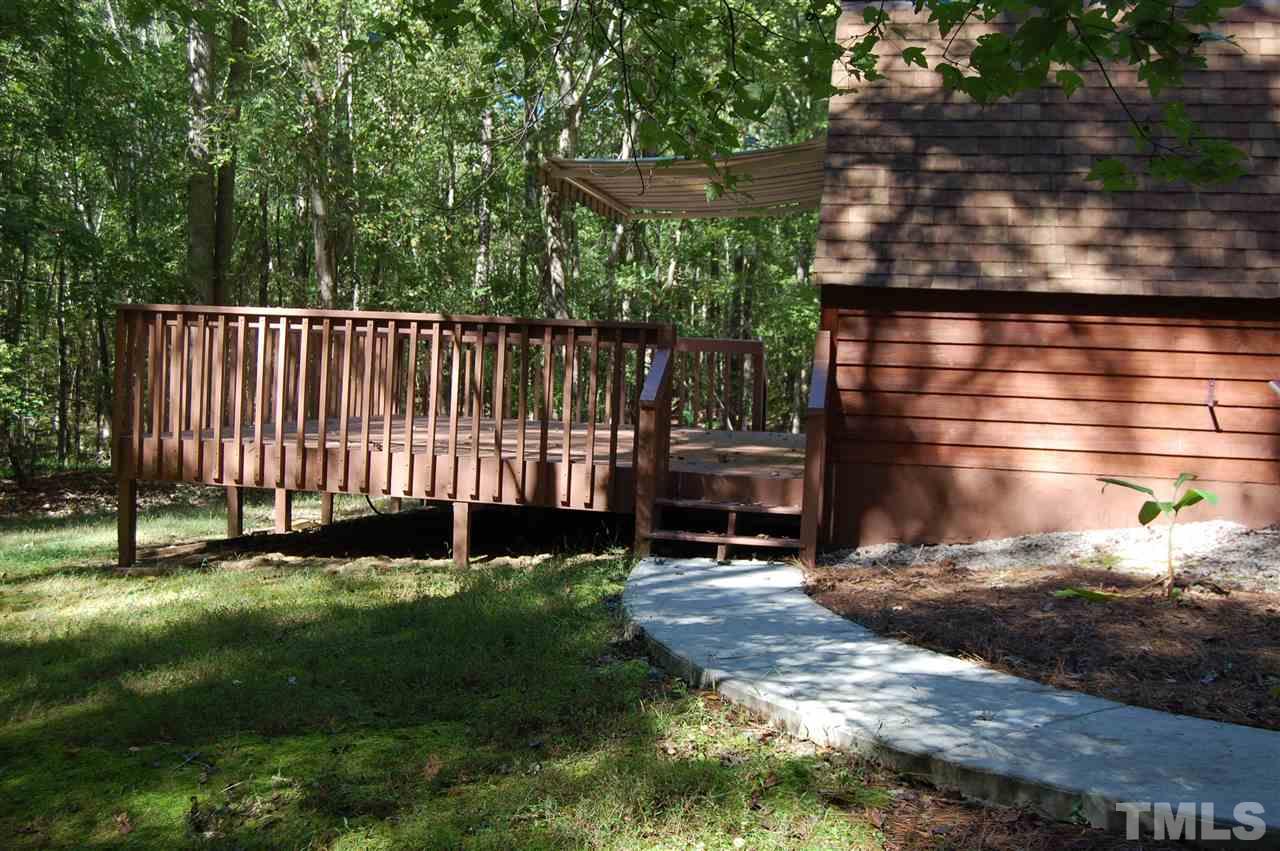1121 Batchelor Road Apex, NC 27523 - Photo 9 of 30 Walk from side patio/garage/hot tub area to back deck off Dining room. The awning can be partially opened to allow for sun and shade if desired!