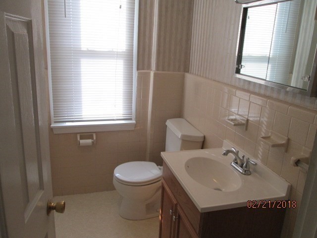 53 Pearl Street, Unit 3 Melrose, MA 02176 - Photo 15 of 20 a bathroom with a sink toilet and a mirror