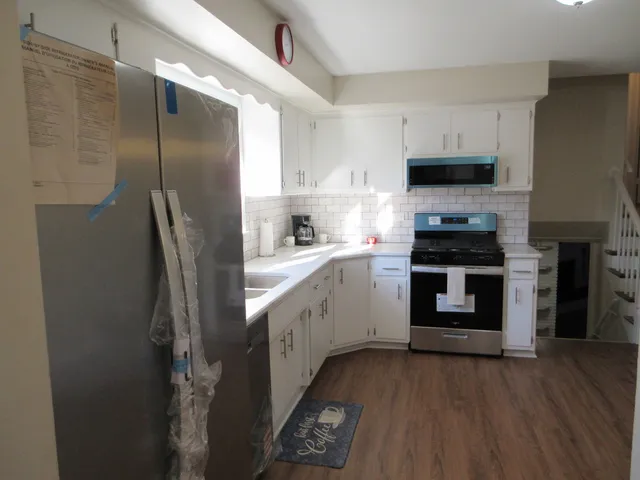 a kitchen with stainless steel appliances a refrigerator stove and sink