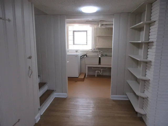 a view of a hallway with workspace and a window
