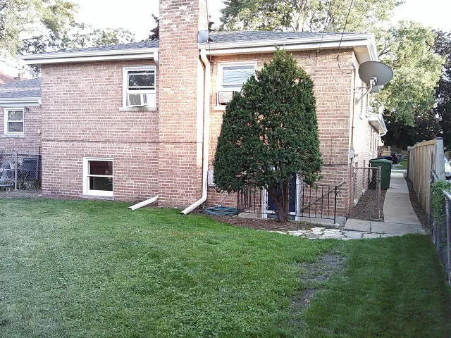 a view of a brick house with a yard