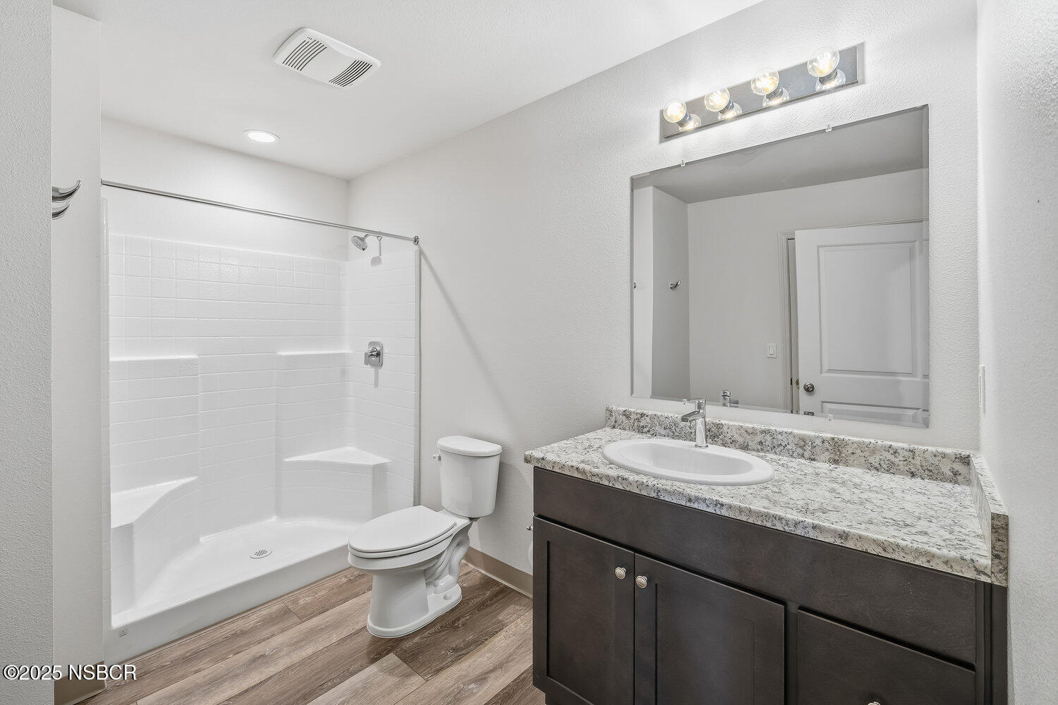 529 South Pine Street Santa Maria, CA 93458 - Photo 16 of 80 a bathroom with a granite countertop sink toilet a large mirror a shower and bathtub