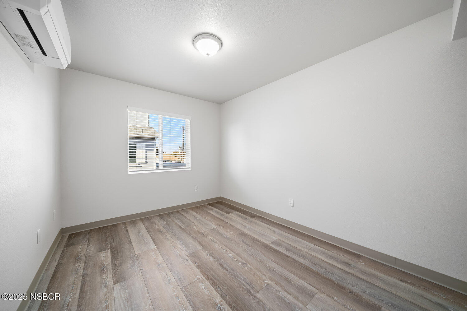 529 South Pine Street Santa Maria, CA 93458 - Photo 23 of 80 an empty room with wooden floor and windows