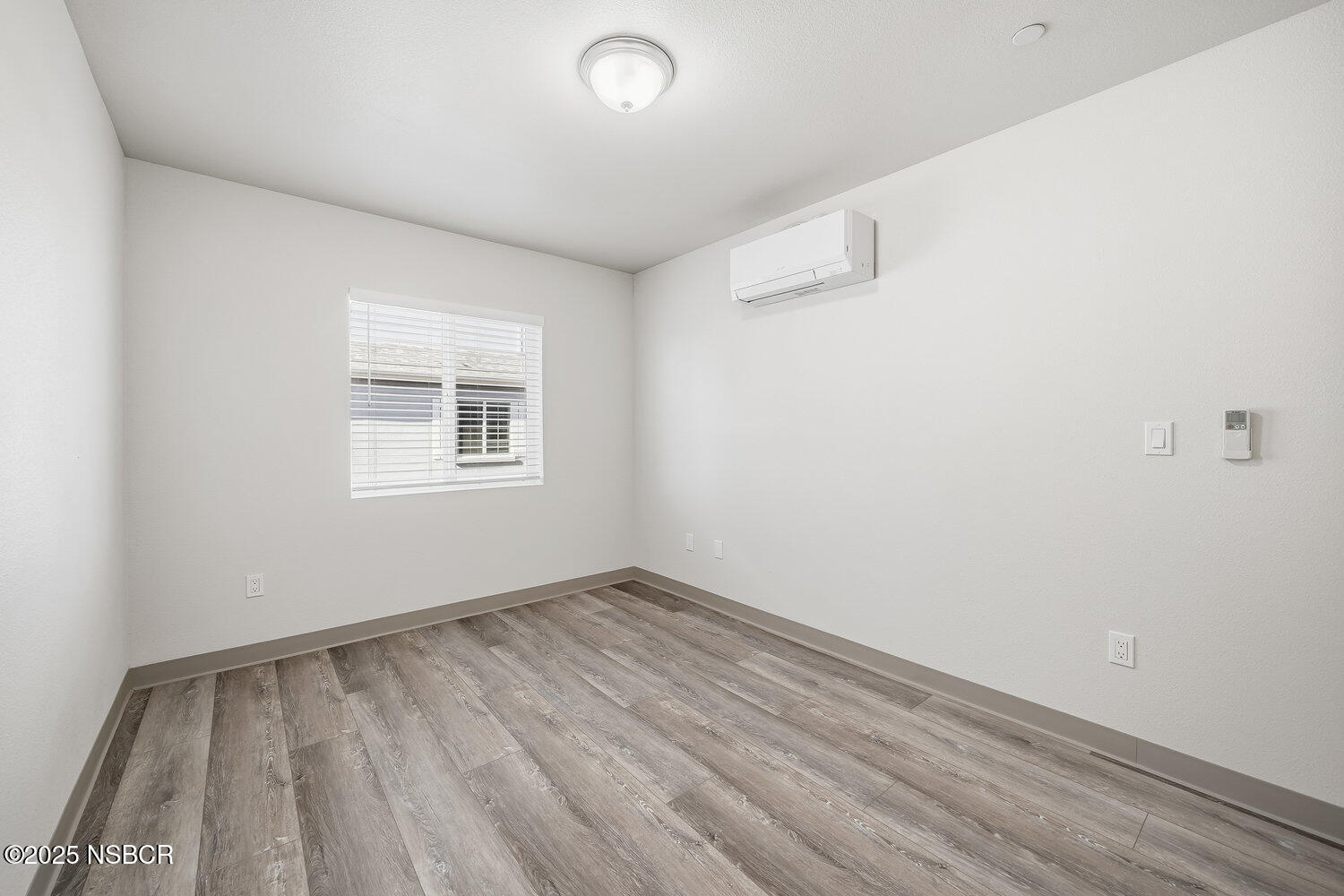529 South Pine Street Santa Maria, CA 93458 - Photo 27 of 80 an empty room with wooden floor and windows