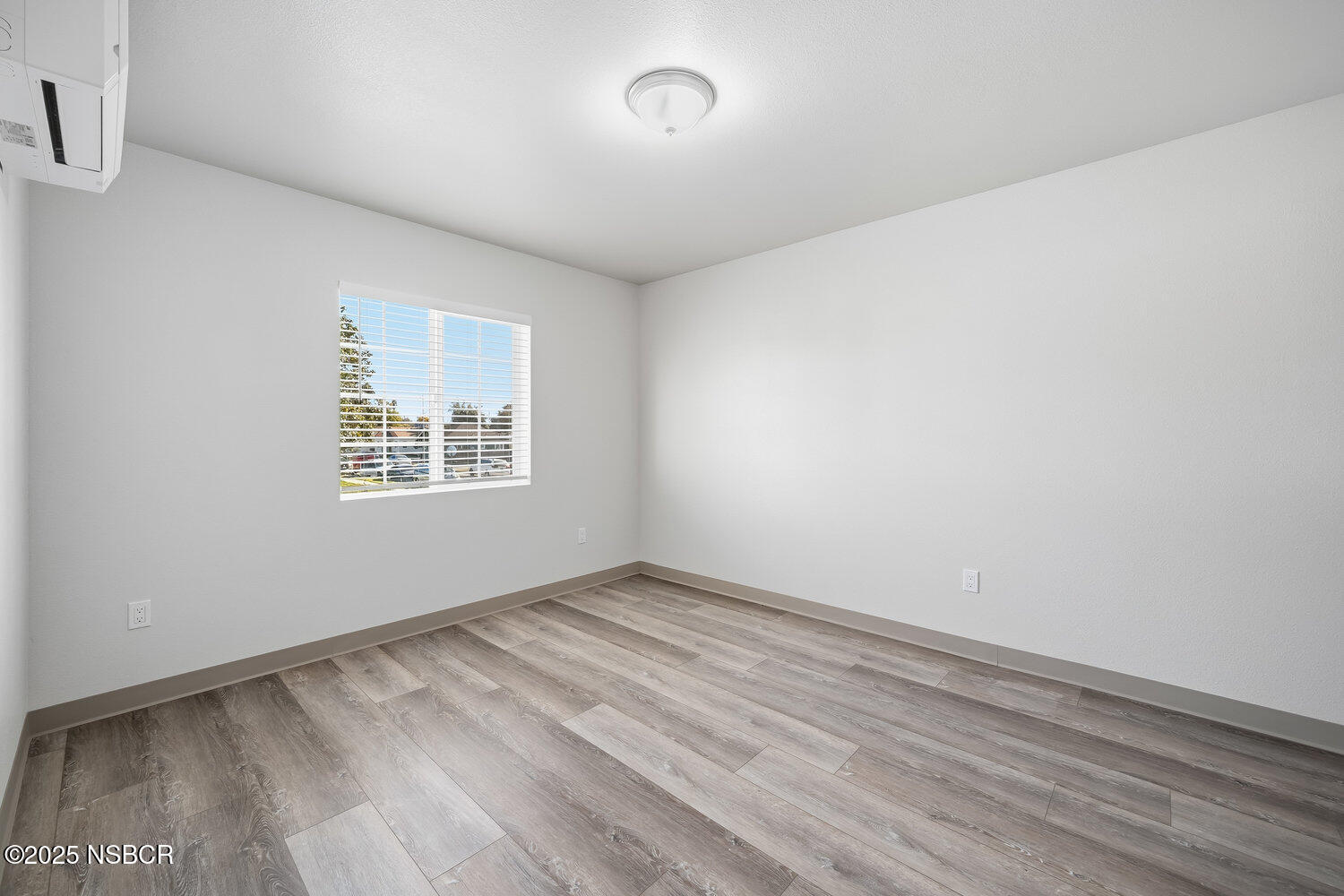 529 South Pine Street Santa Maria, CA 93458 - Photo 29 of 80 an empty room with wooden floor and windows
