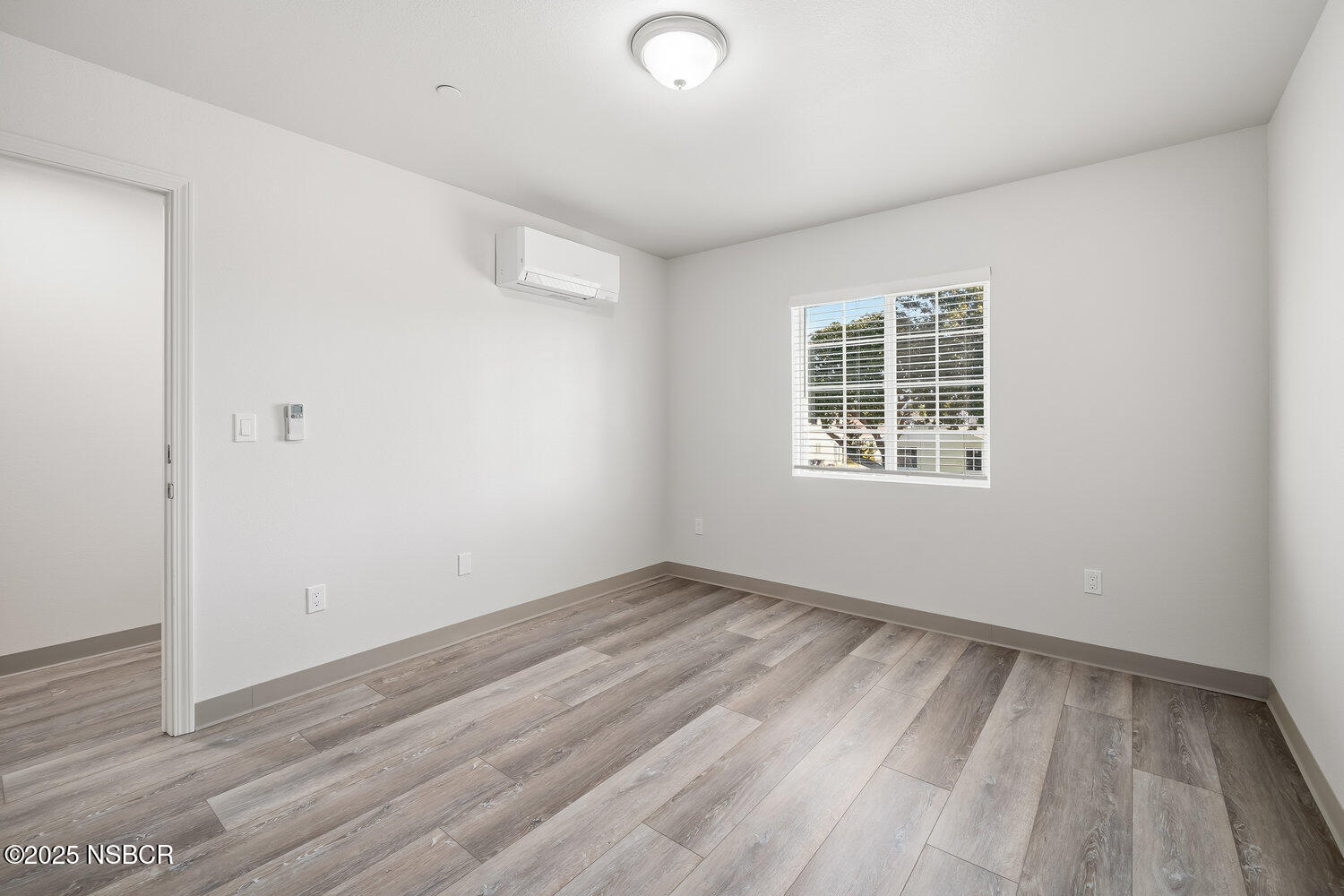 529 South Pine Street Santa Maria, CA 93458 - Photo 30 of 80 an empty room with wooden floor and windows