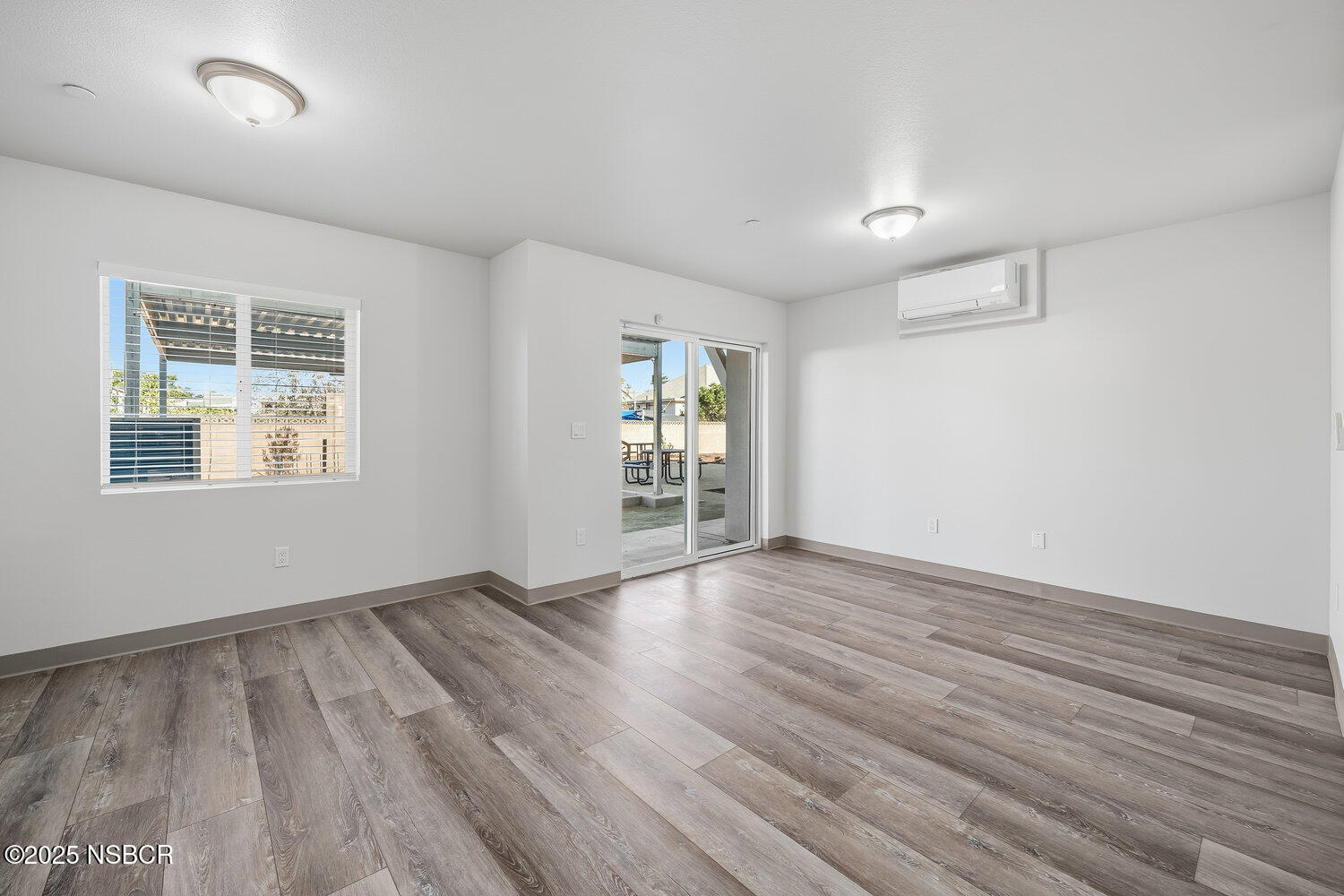 529 South Pine Street Santa Maria, CA 93458 - Photo 38 of 80 an empty room with wooden floor and windows