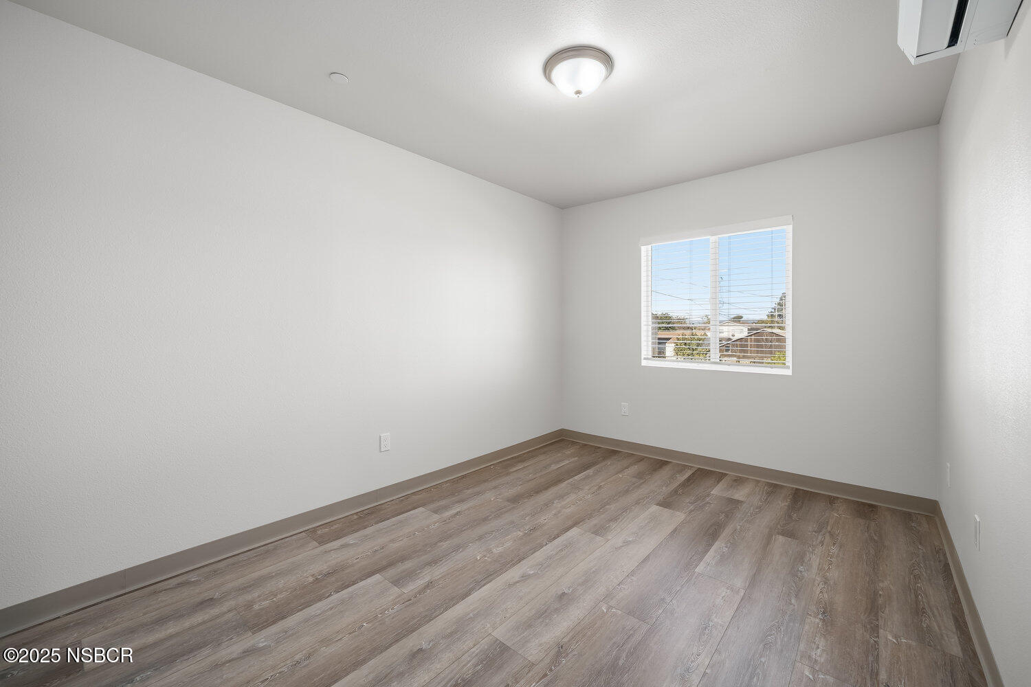 529 South Pine Street Santa Maria, CA 93458 - Photo 45 of 80 an empty room with wooden floor and windows