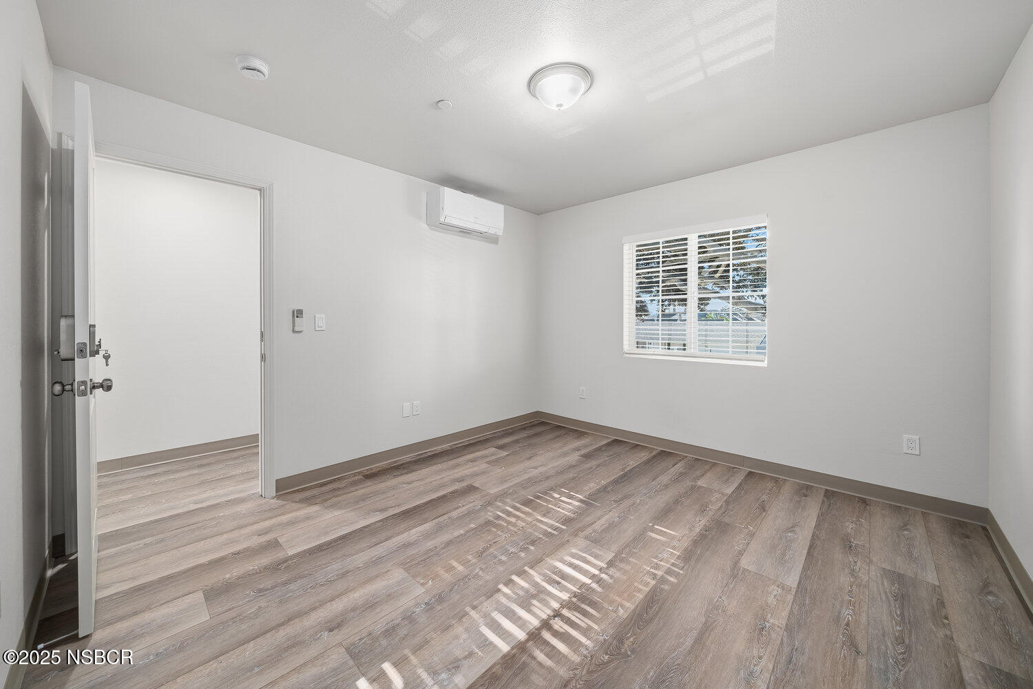 529 South Pine Street Santa Maria, CA 93458 - Photo 49 of 80 a view of an empty room with wooden floor and a window