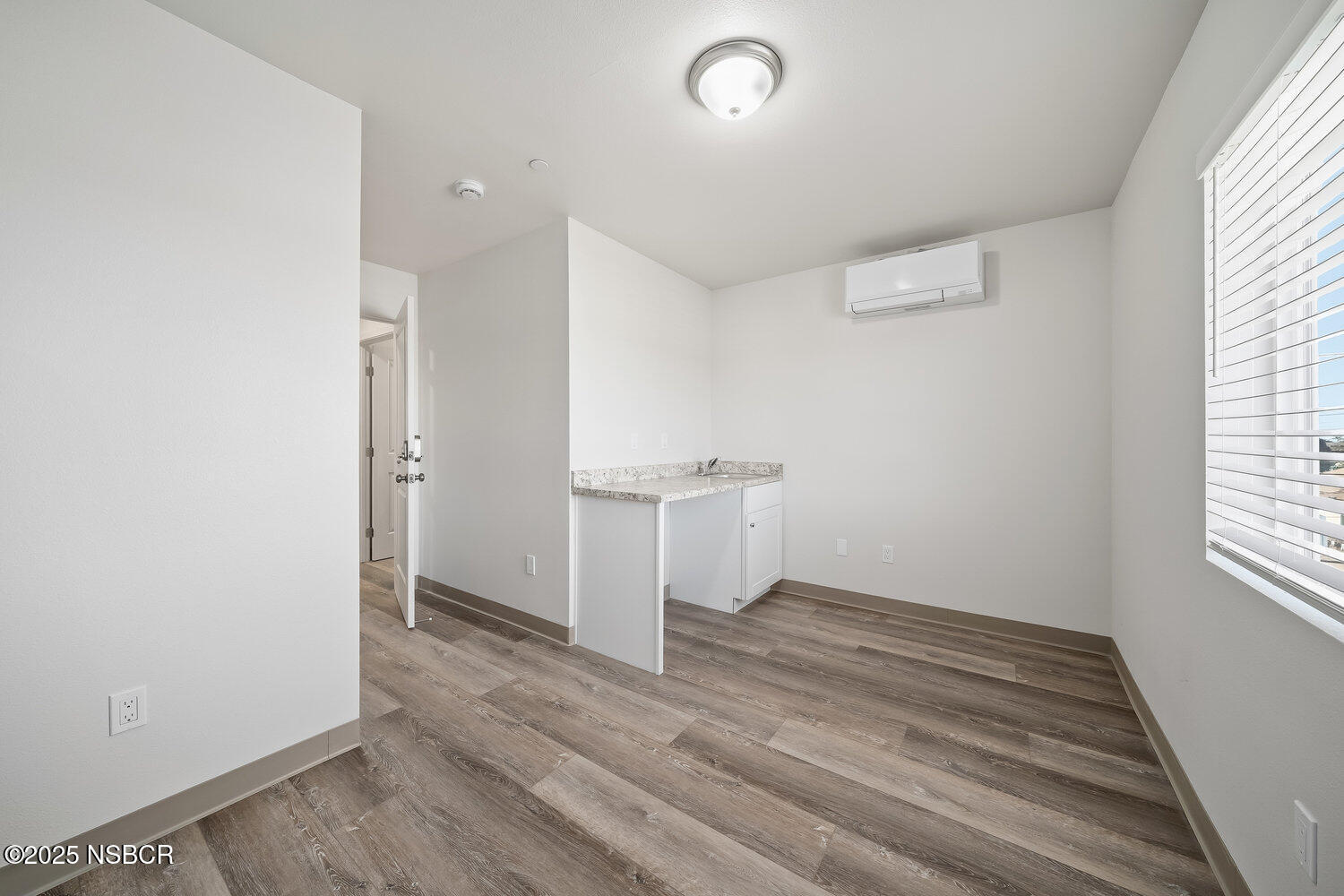 529 South Pine Street Santa Maria, CA 93458 - Photo 54 of 80 an empty room with wooden floor and windows