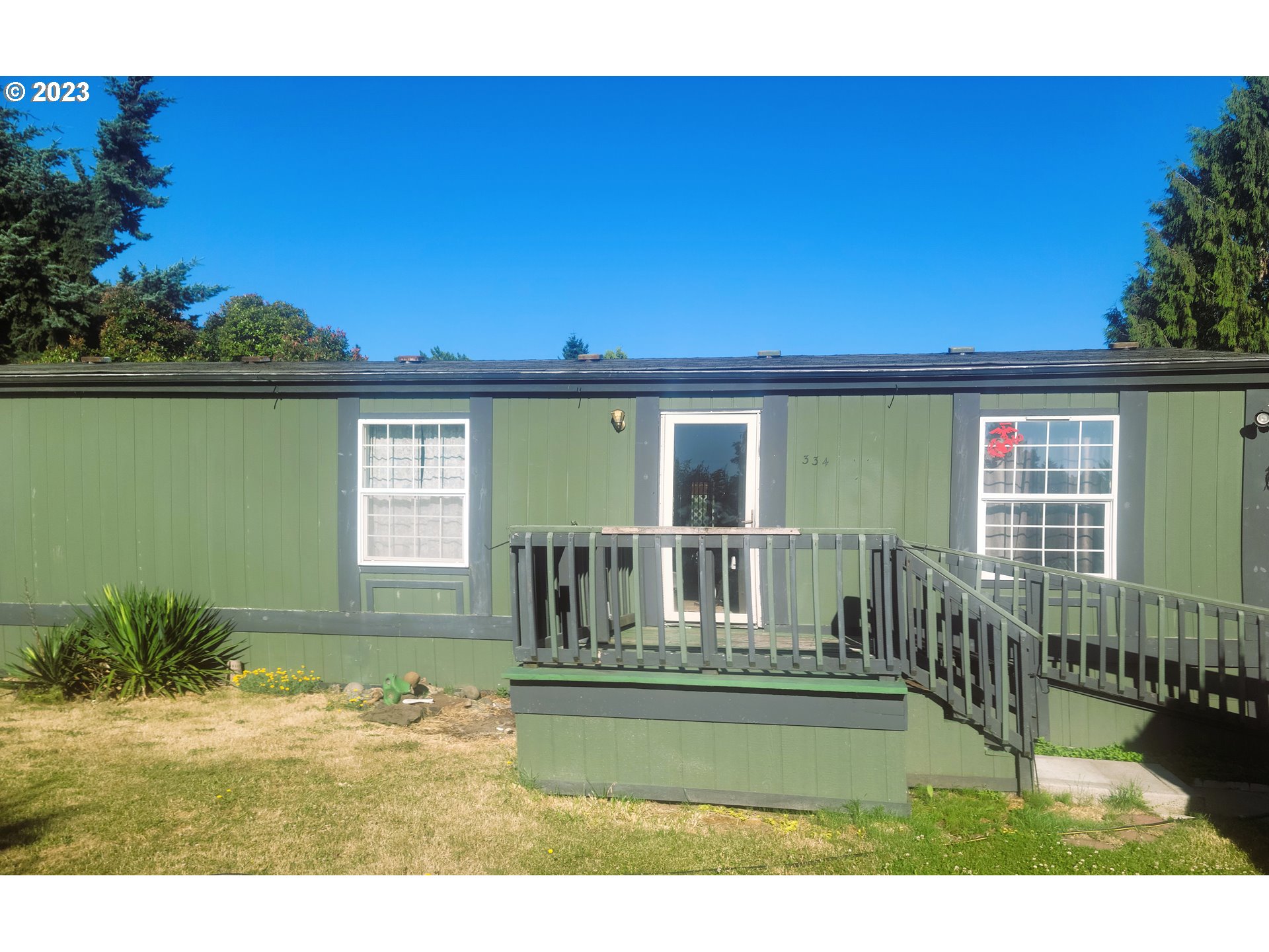 a view of a house with backyard outdoor seating and deck