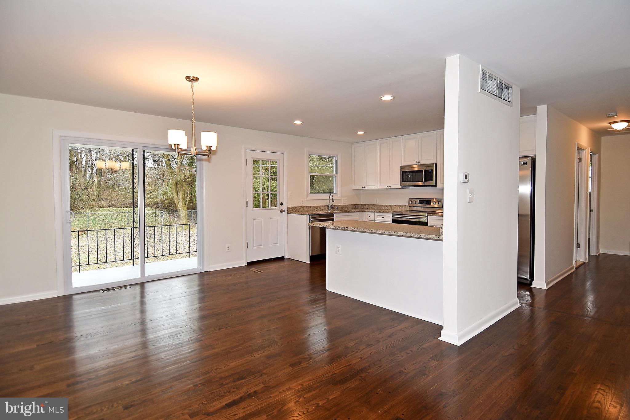 8609 Woodspring Road Randallstown, MD 21133 - Photo 15 of 43 a view of kitchen with refrigerator and wooden floor