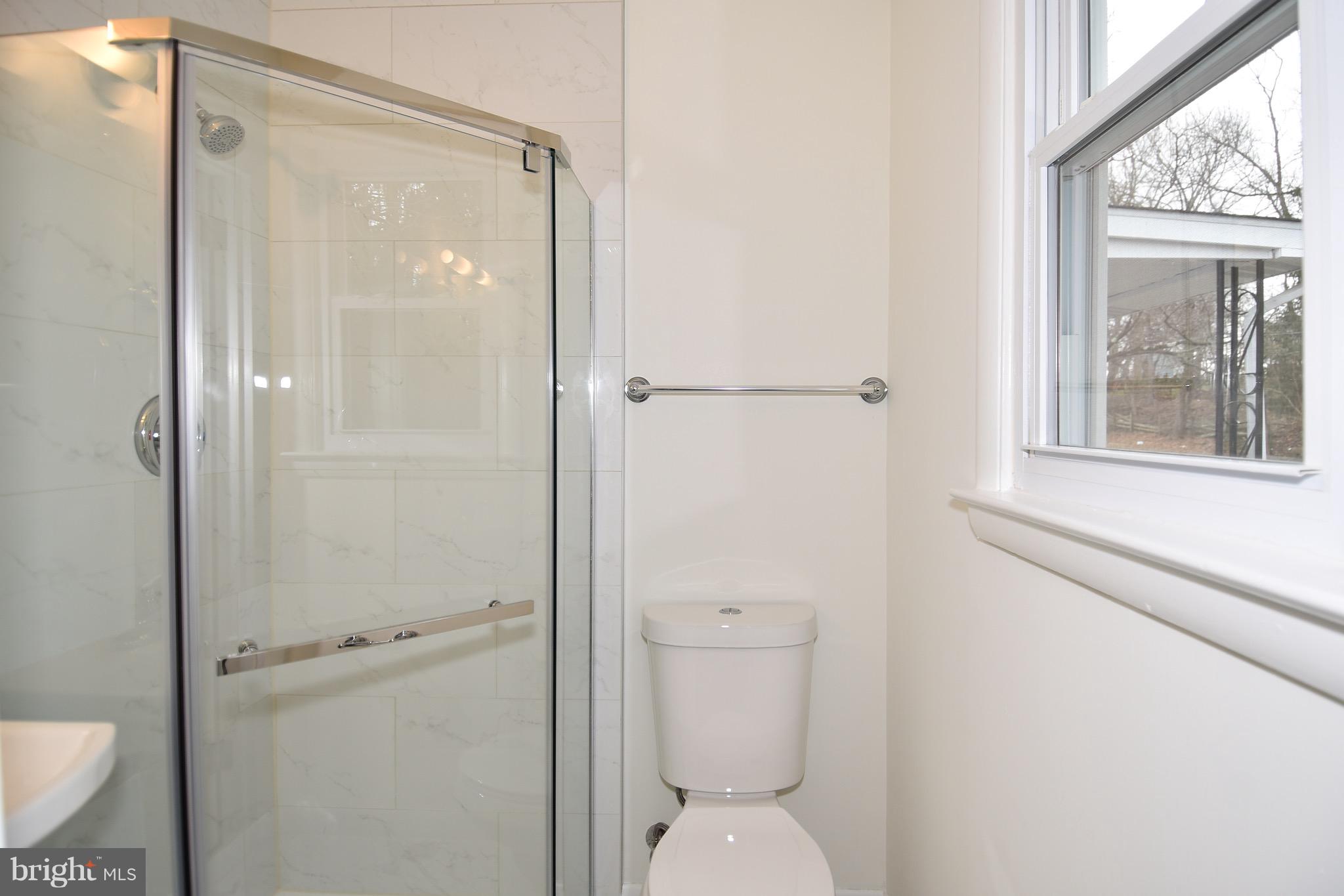 8609 Woodspring Road Randallstown, MD 21133 - Photo 22 of 43 a bathroom with a granite countertop toilet a sink and a mirror