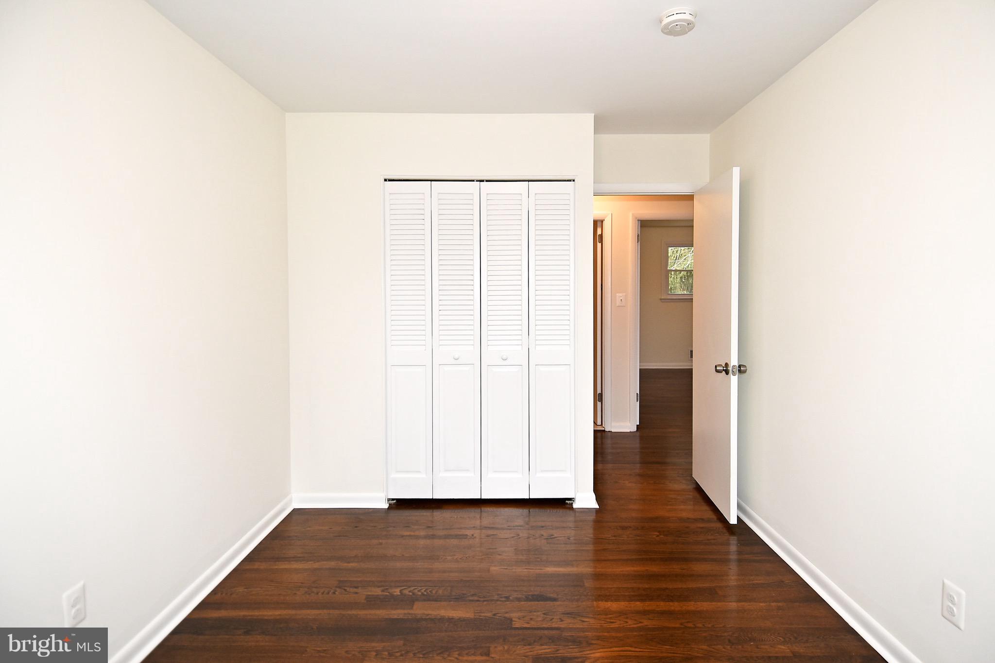 8609 Woodspring Road Randallstown, MD 21133 - Photo 26 of 43 a view of an empty room with wooden floor