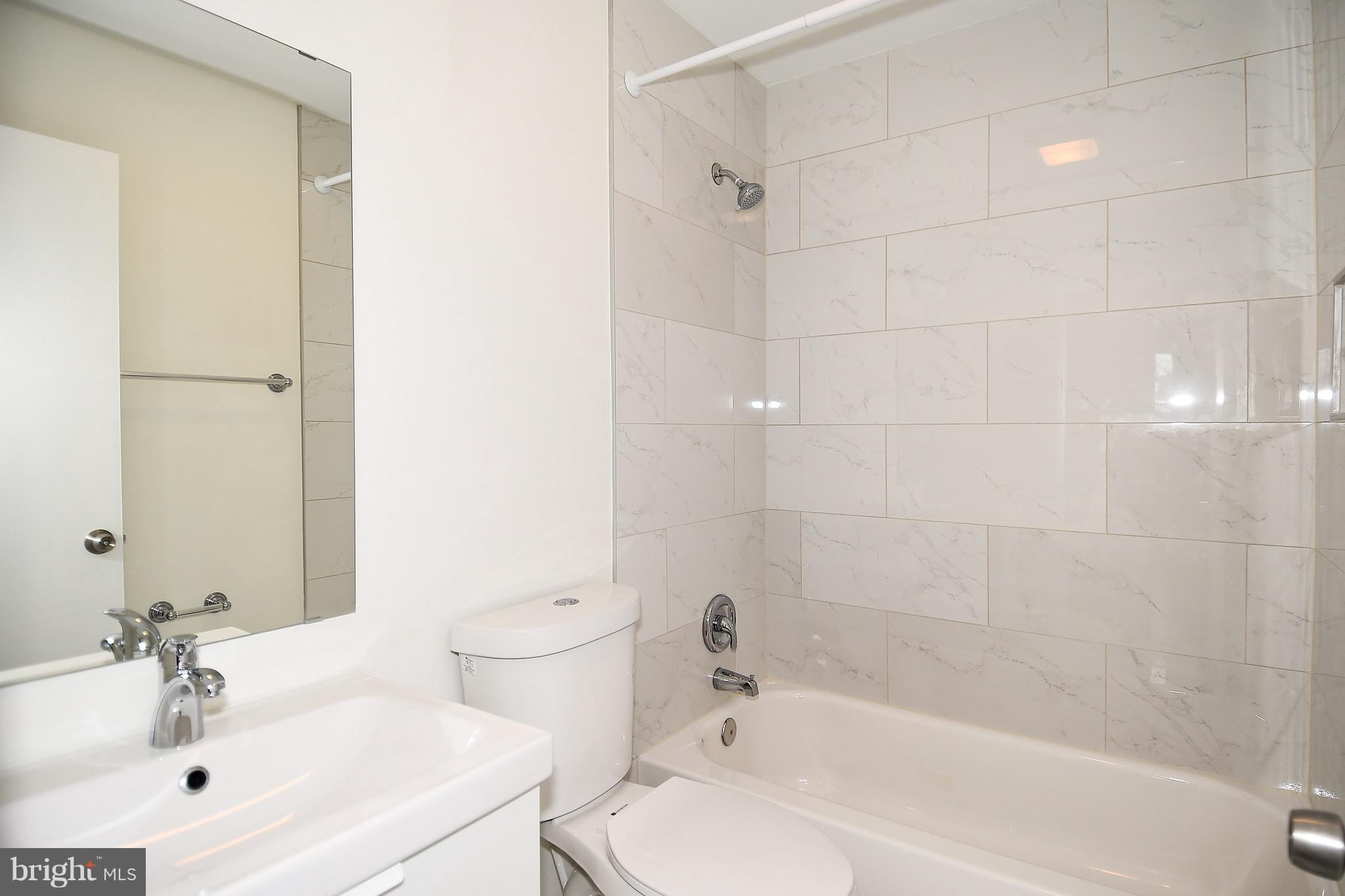 8609 Woodspring Road Randallstown, MD 21133 - Photo 27 of 43 a bathroom with a sink a toilet and shower