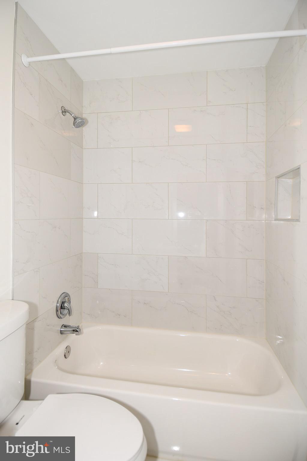 8609 Woodspring Road Randallstown, MD 21133 - Photo 28 of 43 a bathroom with a shower and a bathtub